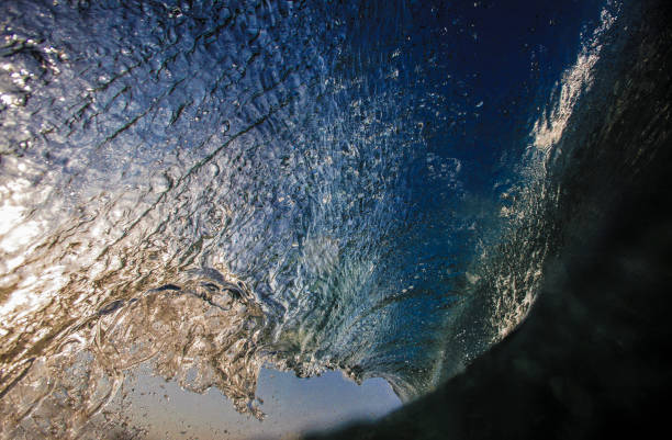 istock Blue surfing wave view from inside the tube 1163027849