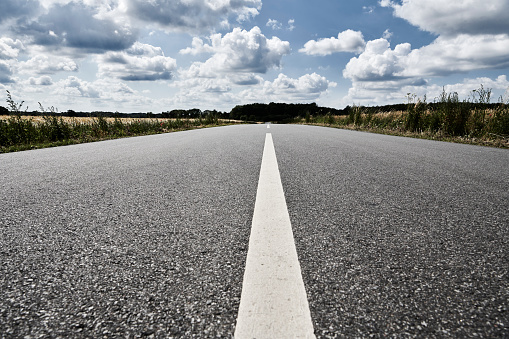 Asphalt road in the countryside. Diminishing perspective and road with dividing line
