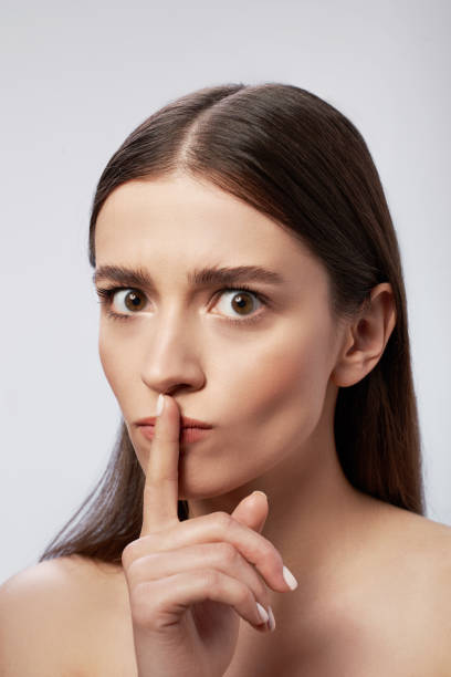 istock Young lady with perfect skin posing against light gray background 1163030225