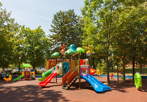 Colorful park playground for kids, during summer day.