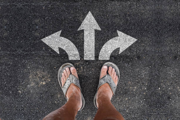 istock man in slippers and three direction arrow choices 1163030458