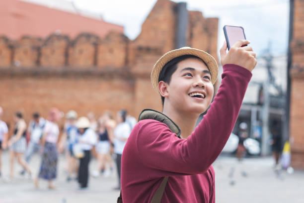 istock Young traveller taking a photo with smart phone. 1163032360