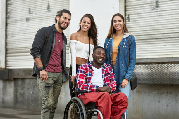 istock Disabled African-American Man Outdoors with Hispanic Friends 1163038090