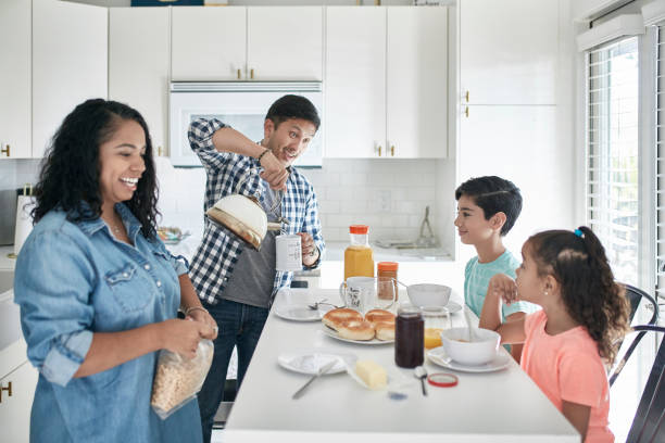 istock Cheerful Mixed Race Family Eating Breakfast in Kitchen 1163038159