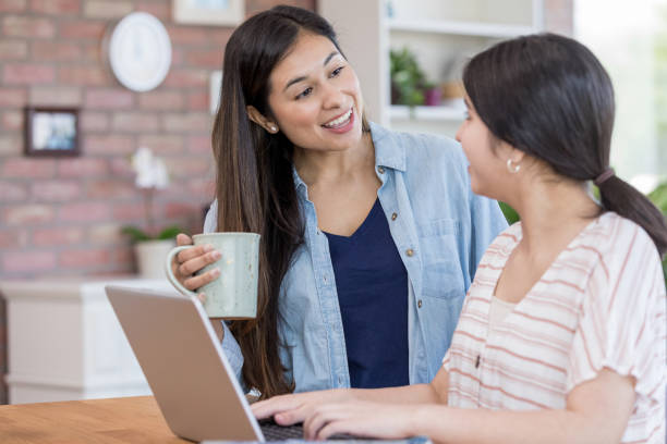 istock Mom and daughter using laptop 1163038222