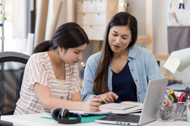 istock Mom teaches daughter at home 1163038245