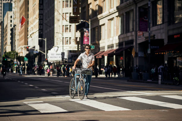 istock Caucasian Man Walking Bicycle Through Downtown Los Angeles 1163038280