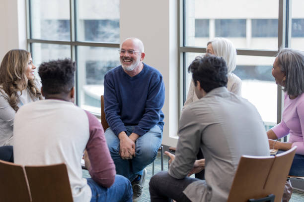 Diverse people sit in circle and brainstorm ideas The multi-ethnic community group sit in a circle and brainstorm ideas group therapy photos stock pictures, royalty-free photos & images