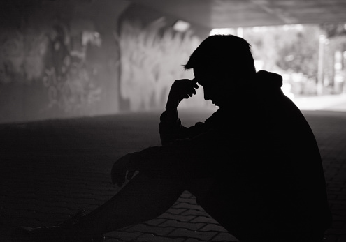 Sad young man on a street