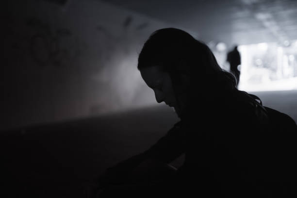 istock Sad young woman on a street 1163040373