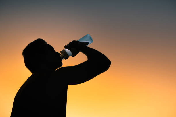 istock Man drinking water outdoors 1163041086