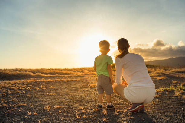 istock Mother and child watching the sunset. 1163041122