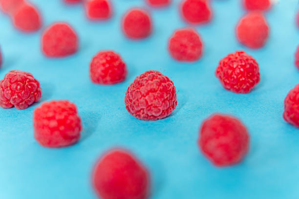 istock Colorful pattern of raspberries on blue background. Top view. Flat lay, pattern 1163042845