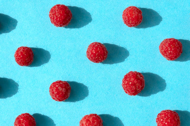 istock Colorful pattern of raspberries on blue background. Top view. Flat lay, pattern 1163042938
