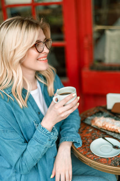 istock Happy woman is sitting in cafe and having breakfast 1163044962