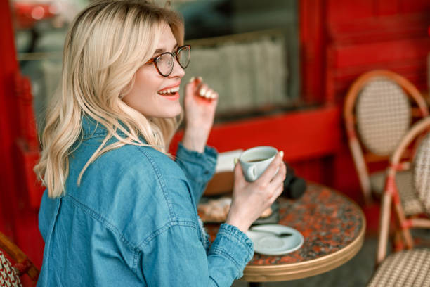 istock Happy lady is sitting in cafe and having breakfast 1163044964