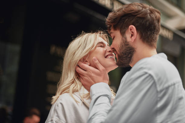 Smiling man is looking at the happy woman