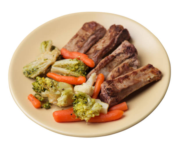 istock grilled pork ribs with broccoli cabbage, carrots and garlic on a plate. fried   ribs with vegetables on a white background. hearty rustic food top view 1163049774