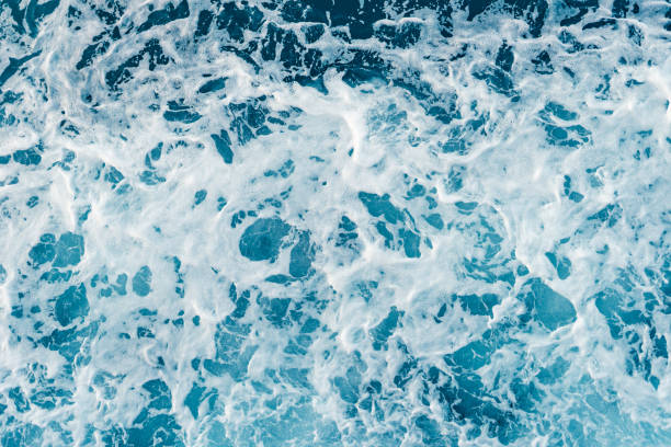 istock High angle view on the sea ocean wave foam water splash blue and white background 1163049980