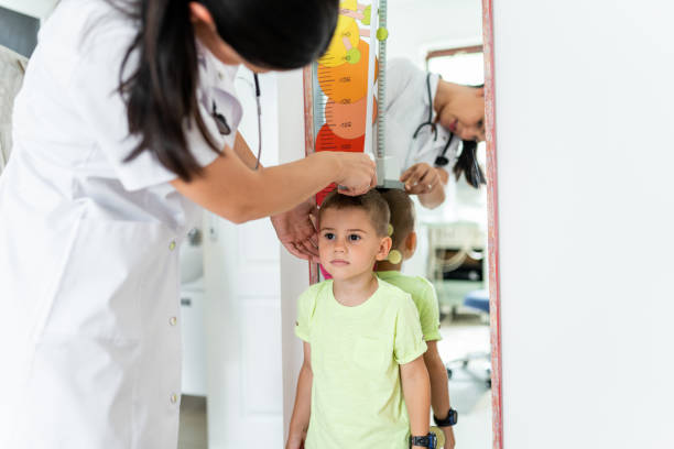 istock Doctor measuring height 1163053958