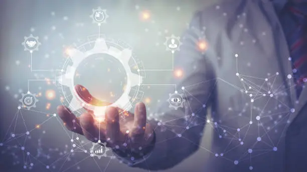 Photo of Business process management and workflow automation diagram with gears and icons with connection line network in background. Manager touching interface