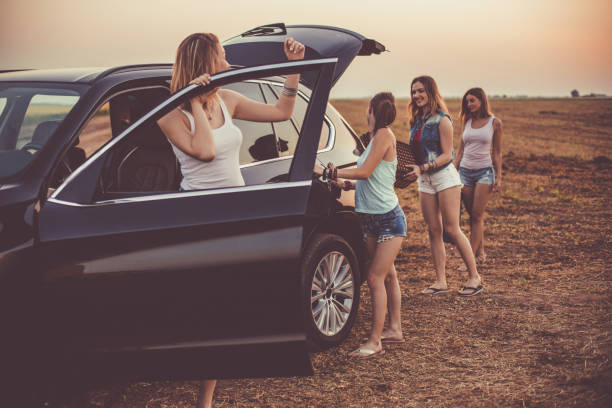 istock Girlfriends preparing their car before going on adventurous road trip together 1163060703