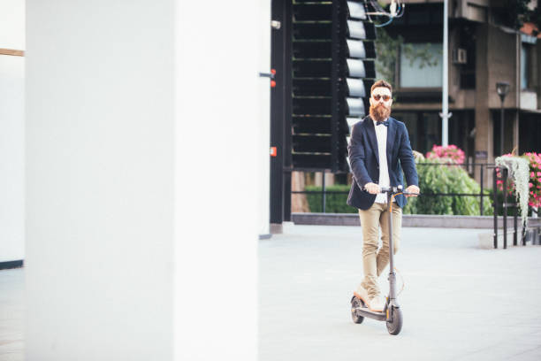 istock Hipster riding an electric scooter 1163060813