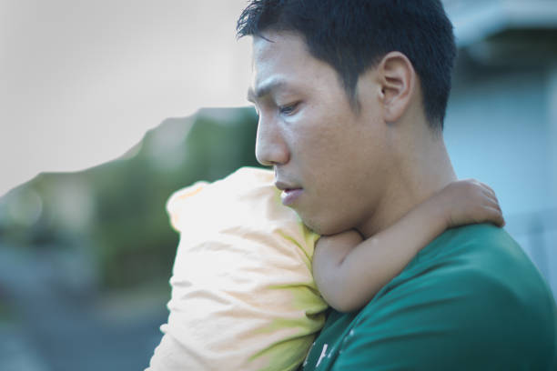 istock Tired unhappy father holding his baby. Postpartum depression. 1163061027