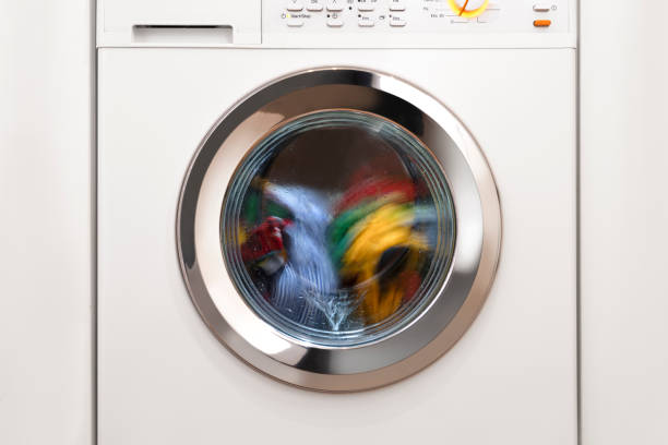 Washing machine with laundry Washing machine with laundry fabric softener photos stock pictures, royalty-free photos & images