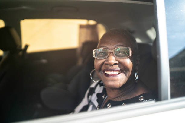 Portrait of senior passenger looking at camera Portrait of senior passenger looking at camera black taxi stock pictures, royalty-free photos & images