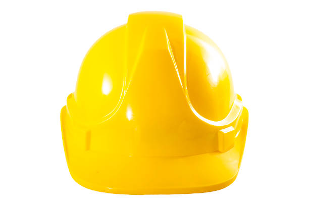 Industrial workers or construction site safety equipment concept with front view of a yellow hard hat isolated on white background with a clipping path cut out