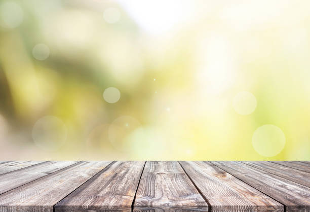 istock Abstract natural green bokeh background and wooden tabletop 1163072238