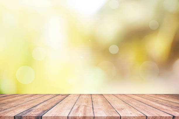istock Abstract natural green bokeh background and wooden tabletop 1163072242