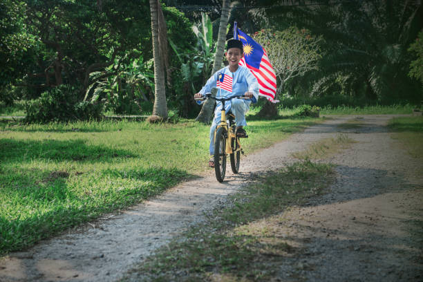 istock Happy Malaysian boy rides a bicycle during Merdeka celebration 1163075979
