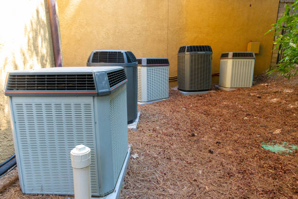 istock Group of air conditioner units next to building 1163077540