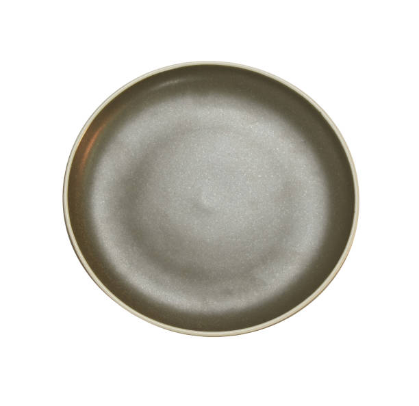 istock Brown round ceramic plate isolated on white background. Top view. 1163081121