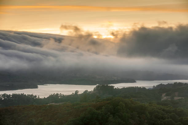 Fog Rolling over Crystal Springs Reservoir as seen from a vista point off Highway 280 on a Summer Sunset. Redwood City, San Mateo County, California, USA. redwood city stock pictures, royalty-free photos & images