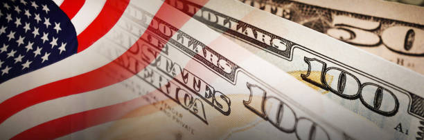 American flag and banknotes (USD) currency money stock photo