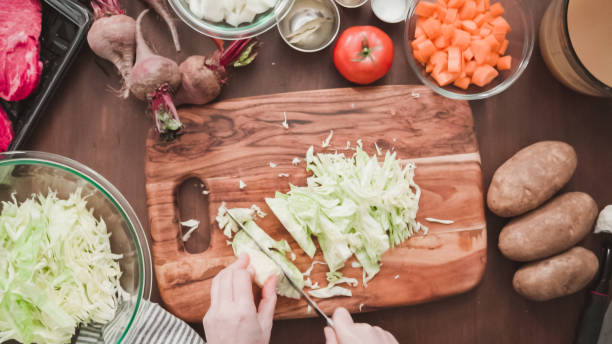 istock Shredding green cabbage for beet soup, borscht. 1163087973