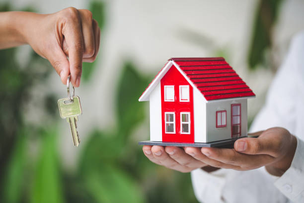 your new house, real estate agent holding house key to his client after signing contract agreement in office,concept for real estate, renting property - key real estate key ring house key imagens e fotografias de stock