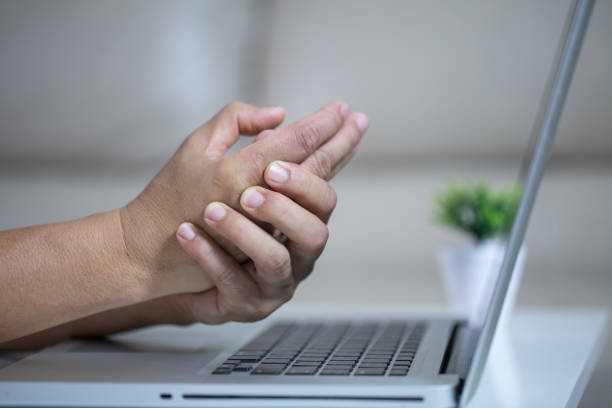 istock Man holding her wrist pain from using computer. Office syndrome 1163095168
