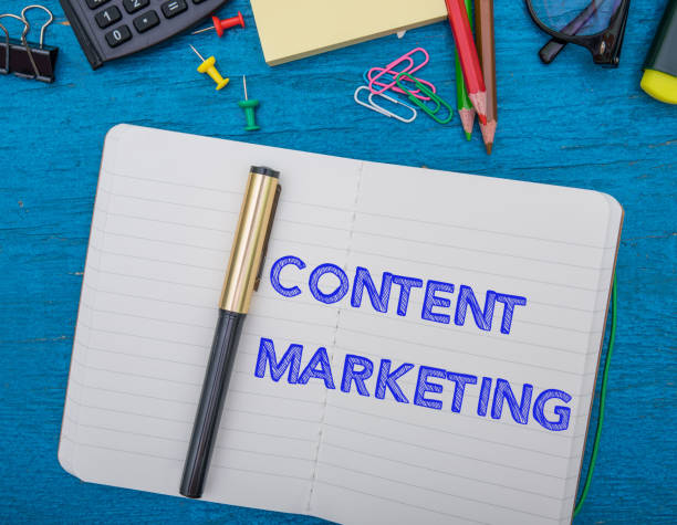 istock 'Content Marketing' Word On Note Book With Pen And Office Supplies On Blue Table 1163098437