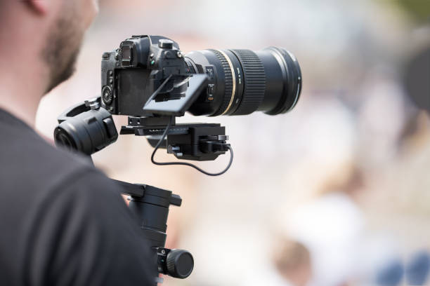 istock Video shooting with a camera with a tripod with a black stabilizer 1163099232