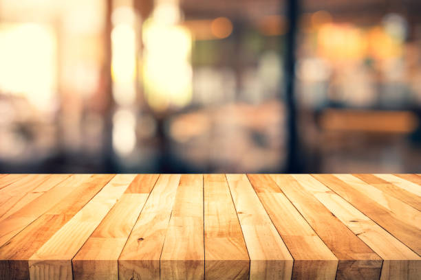 istock Wood texture table top (counter bar) with blur light gold bokeh in cafe,restaurant background 1163099272