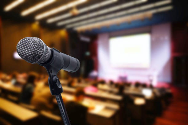 istock Microphone over the blurred business forum Meeting or Conference Training Learning Coaching Room Concept, Blurred background. 1163100599