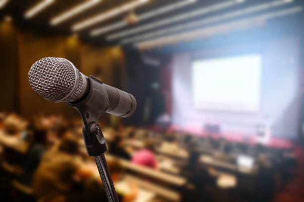 istock Microphone over the blurred business forum Meeting or Conference Training Learning Coaching Room Concept, Blurred background. 1163100601