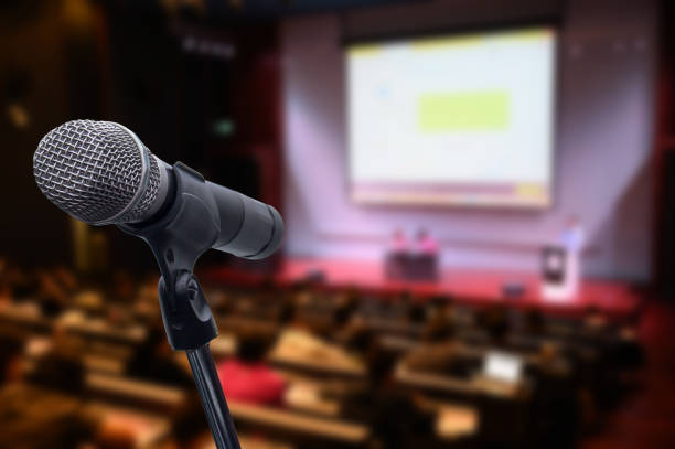istock Microphone over the blurred business forum Meeting or Conference Training Learning Coaching Room Concept, Blurred background. 1163100604