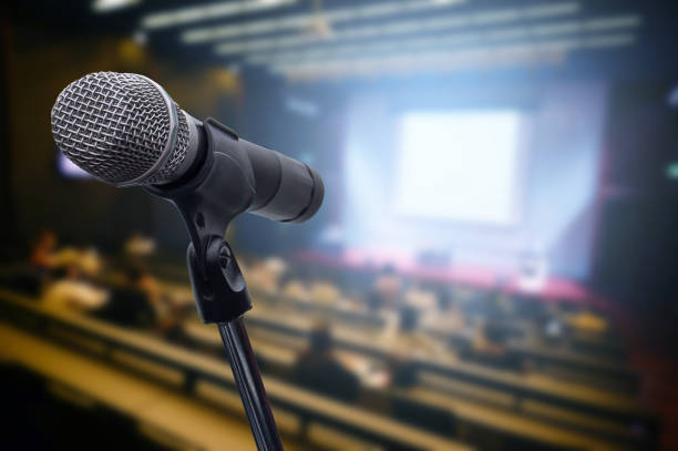 istock Microphone over the blurred business forum Meeting or Conference Training Learning Coaching Room Concept, Blurred background. 1163100611