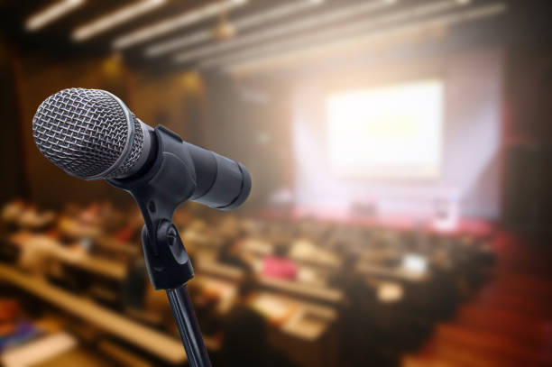 istock Microphone over the blurred business forum Meeting or Conference Training Learning Coaching Room Concept, Blurred background. 1163100613