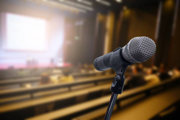 istock Microphone over the blurred business forum Meeting or Conference Training Learning Coaching Room Concept, Blurred background. 1163100642